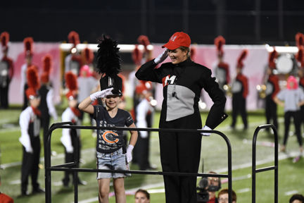Honorary drum major salutes crowd